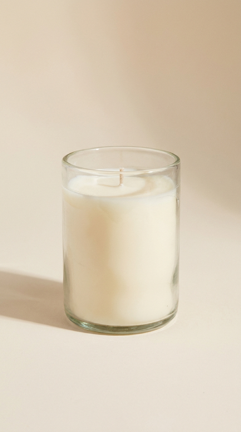 A scented candle in a glass jar