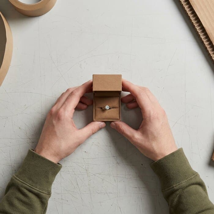 A solitaire ring seated in its open ring box