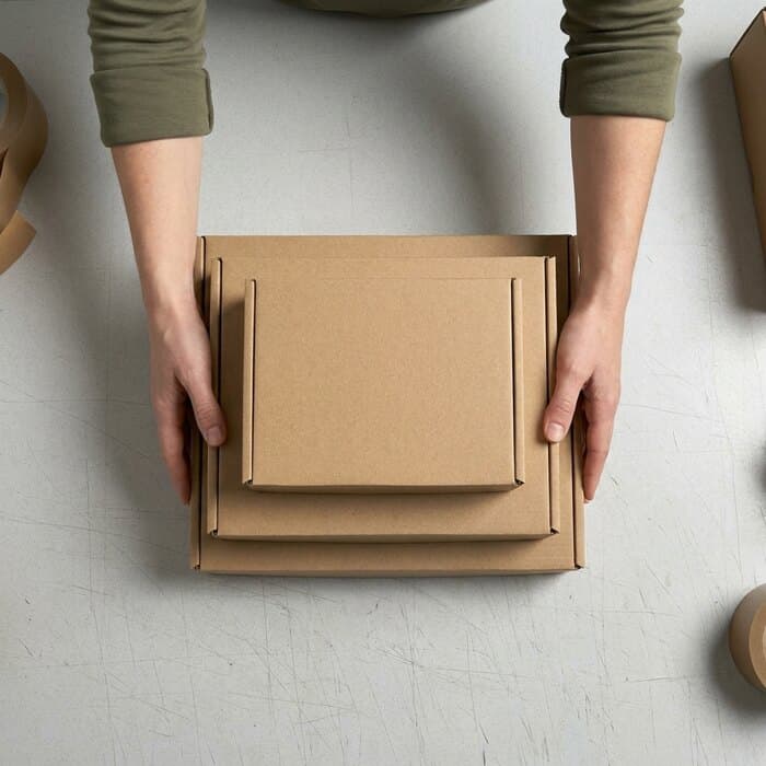 A stack of flat-packed cartons in three sizes